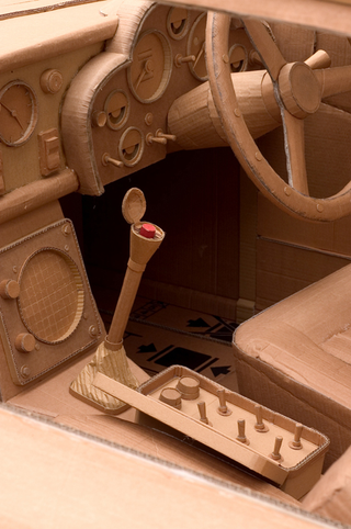 Illustration for article titled Full-Size Cardboard Aston Martin for Papier-Mâché Bonds